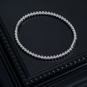 Detail view of silver threaded bead bracelet with industrial cylindrical safety clasps
