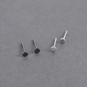 Detailed view of minimalist S925 sterling silver geometric stud earrings in black and silver