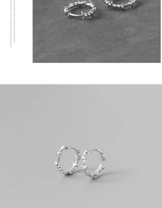 Vue détaillée des boucles d'oreilles épines argentées au design de fil de fer barbelé