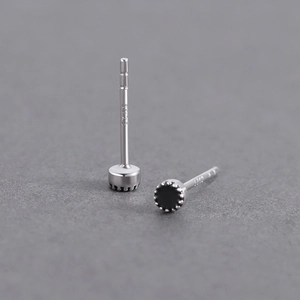 Macro shot of S925 sterling silver stamp on minimalist men's black gemstone stud earring