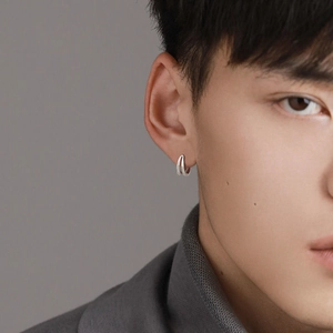 Men's double layered silver hoop earrings with minimalist geometric design on model