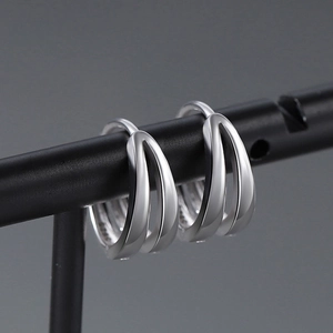 Macro shot of S925 sterling silver hoop earrings with dual-line hollow minimalist design