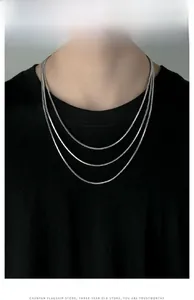 Close-up of three layered silver snake bone chains in 50cm, 55cm and 60cm lengths
