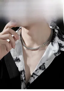 Minimalist stainless steel nameplate necklace on a male model with Cuban chain detail