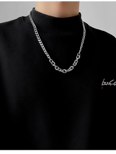 Collana da uomo con maglie d'argento miste e catena cubana su un dolcevita nero