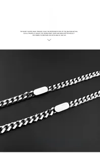 Close-up of titanium steel Cuban chain with dual polished oval ID plates on black background
