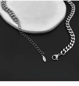 Detail of silver stainless steel Cuban link necklace with lobster clasp and S.Steel tag