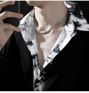 Detail of silver men's Cuban chain necklace with a solid rectangular pendant piece