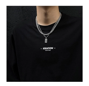 Close-up of double-layer men's Cuban chain necklace with a rectangular relief pendant