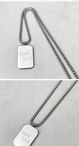 Detailansicht der silbernen rechteckigen Halskette mit Good Luck Gravur und Box-Kette