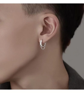 Close-up of silver hoop earrings with hanging chain detail on male ear model