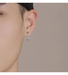 Gros plan d'un mannequin portant des boucles d'oreilles doubles gouttes d'eau en argent