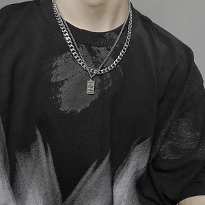 Double-layered silver necklace with Venus relief pendant and industrial cuban chain