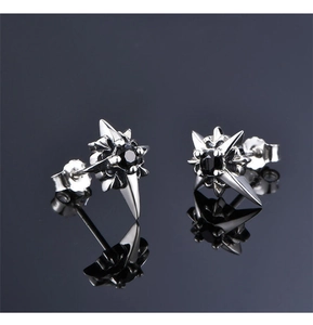 Detailed close-up of North Star stud earrings featuring black zircon on silver metal