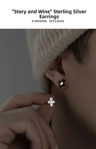 Detailed close-up of cross stud earrings in 925 sterling silver with sparkling stones