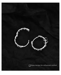 Detailed view of silver hoop earrings with woven texture and comfortable open design