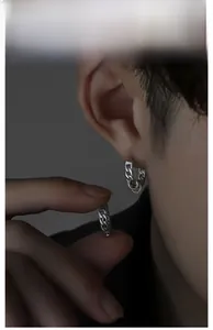 Detail showing the silver Cuban link texture on men's trendy stainless steel hoop earrings
