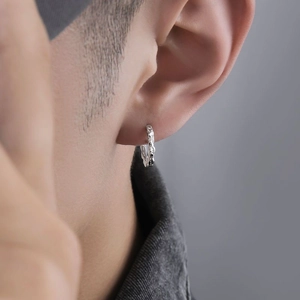 Irregular textured silver huggie hoop earrings for men with minimalist lava design