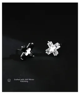 Detailed macro view of cross earrings featuring 360-degree mirror polishing and cubic zirconia