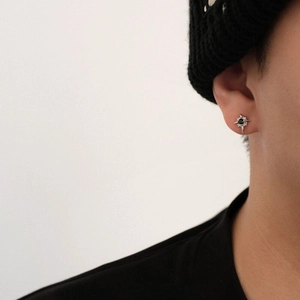 North Star zircon stud earring featuring a black center stone on a silver starburst base