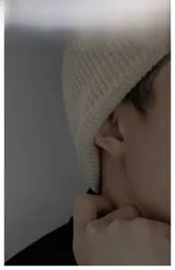 Detailed view of cross stud earring with diamonds worn by model for men style