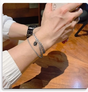 First-person view of men's double-layered titanium steel bracelet with black gemstone