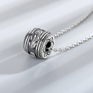 Vintage S925 sterling silver dragon pi xiu necklace with cylinder beads on grey background