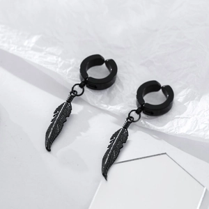 Vue macro de boucles d'oreilles plume noires minimalistes en acier titane mat