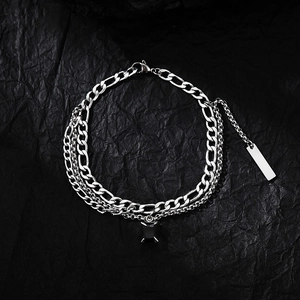 Detail of layered titanium steel chain with square black stone and rectangle metal tag