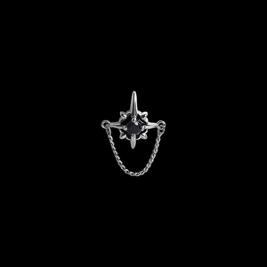 Macro detail of silver star stud earring with black zircon and hanging chain design