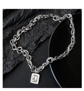 Macro shot of silver hip-hop chain necklace with square zircon pendant and pavé rhinestones