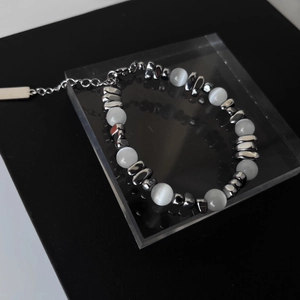 Détail du bracelet avec pierres œil de chat, perles argentées et fermoir mousqueton
