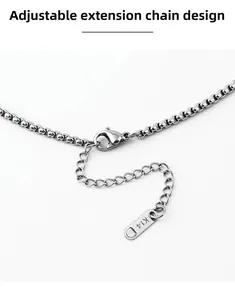 Macro detail of silver box chain with adjustable lobster clasp and K14 metal tag