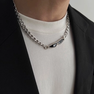Close-up of a creative sunglasses pendant with rhinestones on a silver curb chain