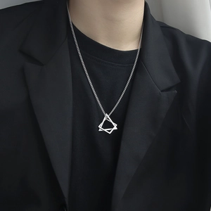 Silver geometric triangle and square nested pendant necklace on black suit outfit