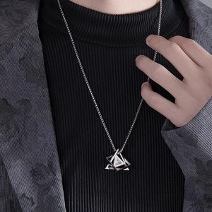 Men's geometric triangle pendant necklace in silver with zircon on a black sweater