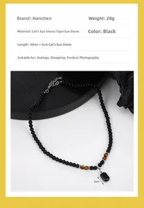 Detailed view of beaded necklace with tiger eye stones and a 5cm black gem pendant
