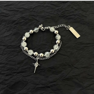 Detail of beaded bracelet featuring ice-crack beads and stainless steel star pendant