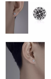 Macro detail of retro silver cross helm stud earring with vintage engraved textures