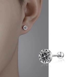 Detailed macro of vintage cross helm stud earring with screw back and engraved pattern