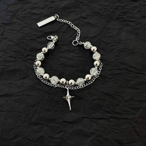 Detail of double-layer bracelet with ice-crack beads and silver star pendant