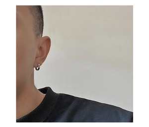 Close-up of men titanium steel hoop earring featuring Greek fret pattern on model