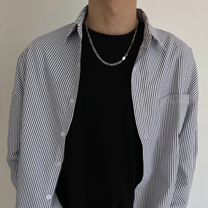 Silver Figaro and cable chain necklace with square buckle clasp on male model