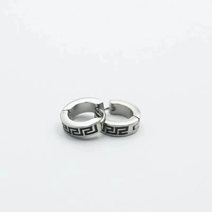 Detail of silver titanium steel earrings with black Greek meander pattern and clasp