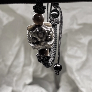 Handcrafted black obsidian lion head bracelet with premium woven rope and brown accent beads