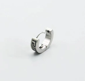 Detail of silver titanium steel huggie earring with black Greek fret pattern and matte finish