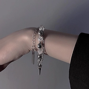 Double-layered steel bracelet with ice crack beads and star charm on wrist