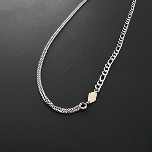 Asymmetric stainless steel necklace with box and Figaro chains and a diamond pendant