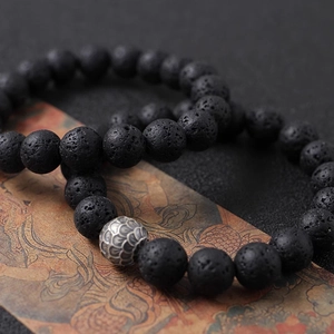 Vintage lava stone beaded bracelet with engraved silver metal bead and zen-style textures