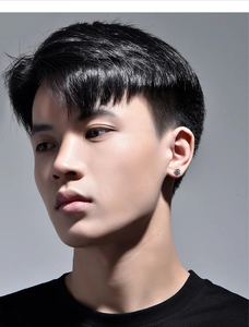 Close-up of minimalist sunburst silver stud earring on a male model in high quality